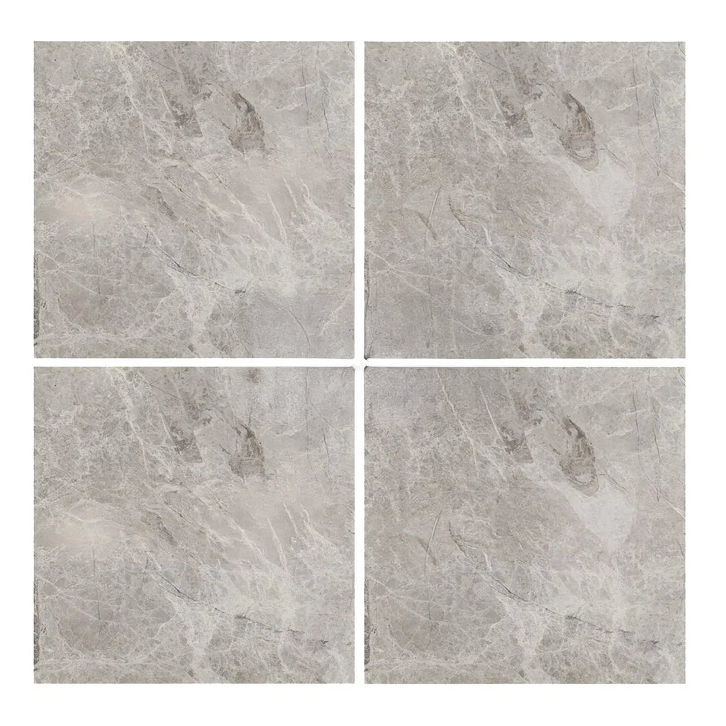 Four square tiles showcase the elegant gray tone and subtle veined pattern characteristic of SurfacesGalore's Atlantic Gray Marble 6X6 Polished-Honed.