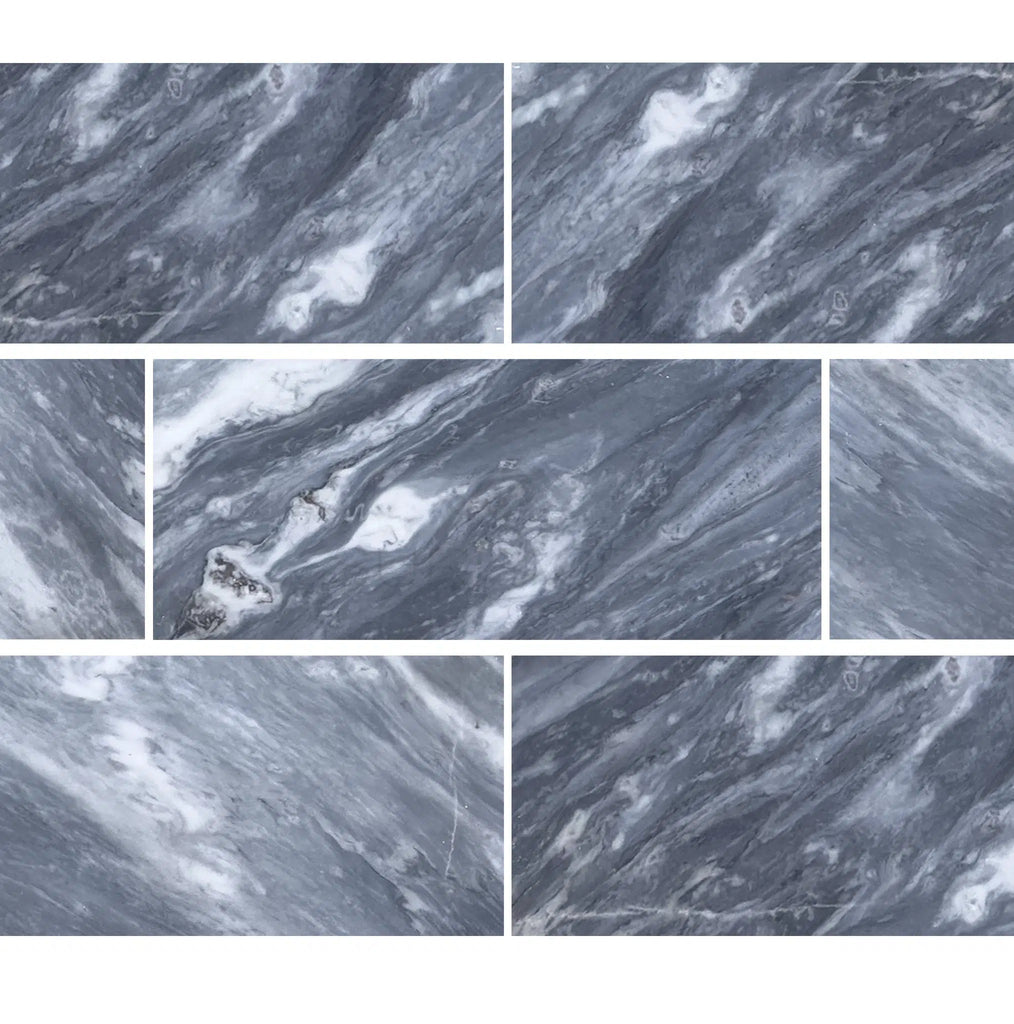 Tiles with a marble texture in shades of gray and white, arranged in a staggered pattern, showcase the elegance of Bardiglio Nuvolato (Italian) 12X24 Marble Polished-Honed. Visit SurfacesGalore to explore this stunning gray marble option for your floor or walls.
