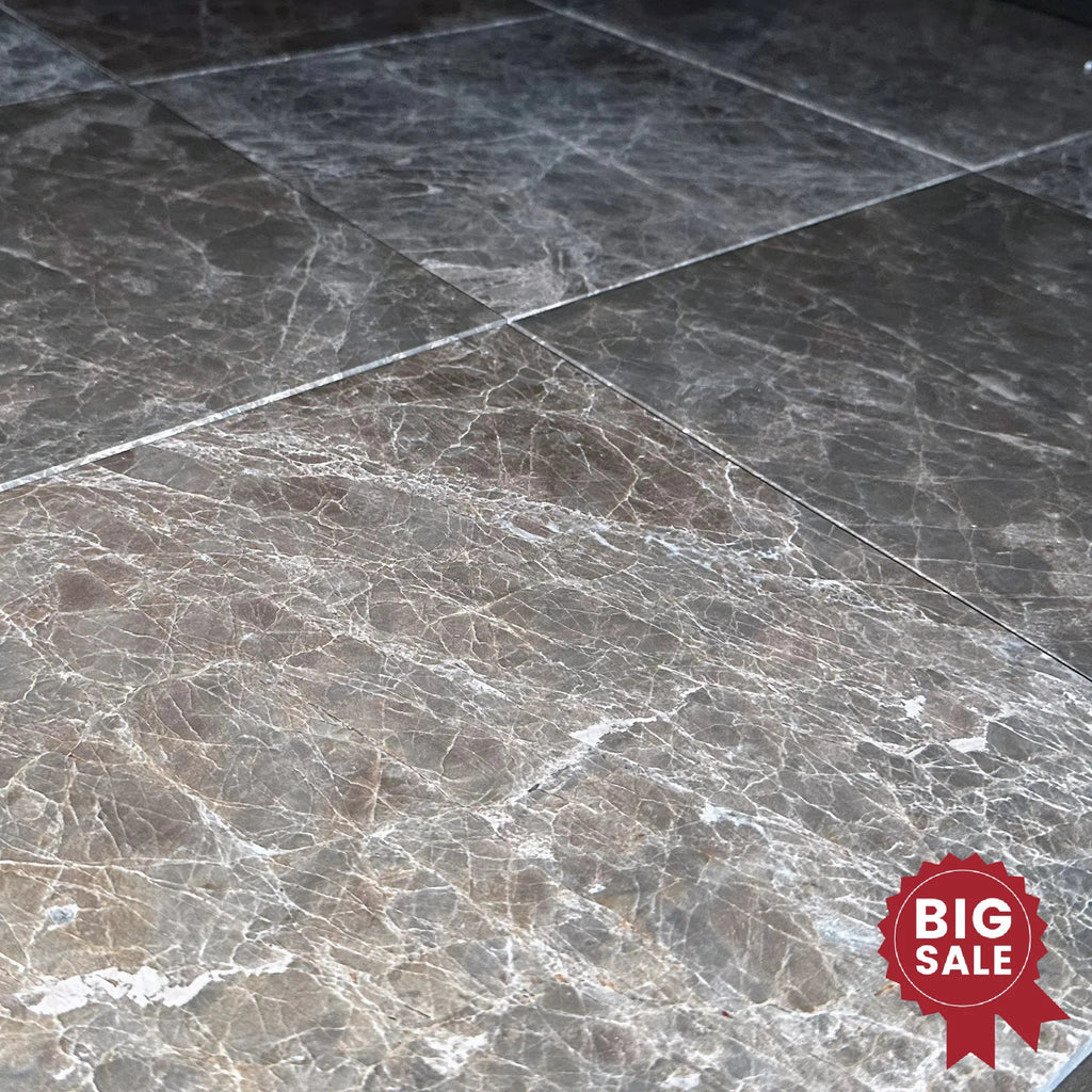 Close-up of glossy Emperador Marble 12x12 polished tiles with a beautiful finish from SurfacesGalore. A red badge in the corner reads "Big Sale" highlighting the Marble/Travertine Clearance.