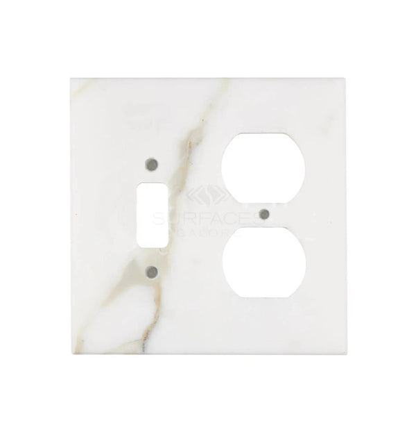 The Calacatta Gold Marble TOGGLE - DUPLEX Switch Wall Plate/Cover Plate/Switch Plate by SurfacesGalore features authentic natural stone craftsmanship, with openings designed for a light switch and two electrical outlets.