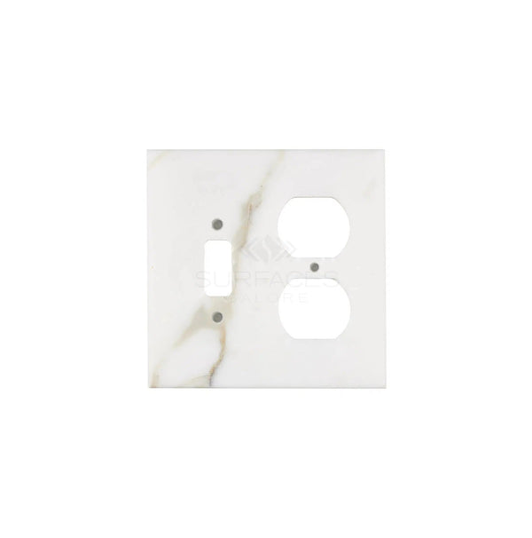 The Calacatta Gold Marble Toggle-Duplex Switch Wall Plate from SurfacesGalore combines elegance and functionality, featuring spaces for a toggle switch and two outlets. Crafted from natural stone, this white switch plate cover adds a touch of sophistication to any room.