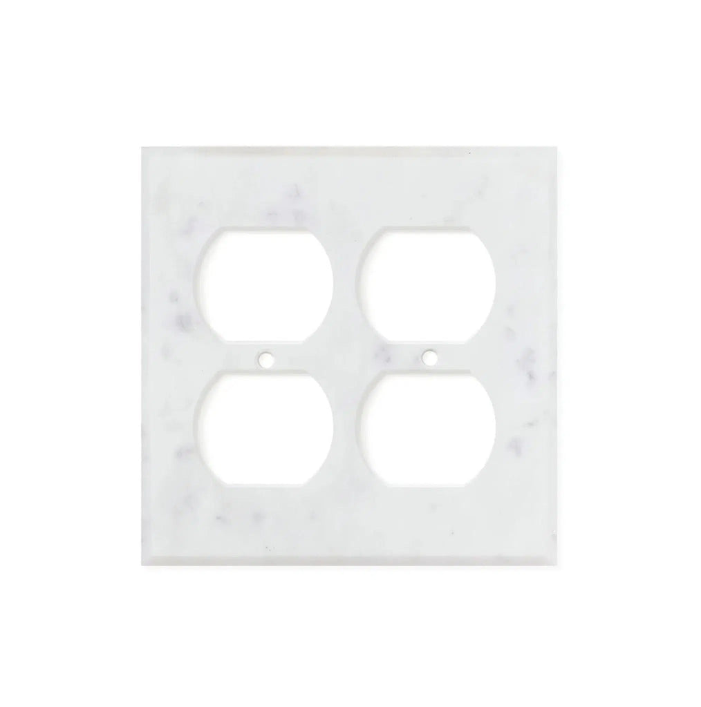 The Carrara White Marble Double DUPLEX Switch Wall Plate from SurfacesGalore features natural stone variations, adding a unique touch to any room. This authentic marble cover plate has four openings for electrical sockets.