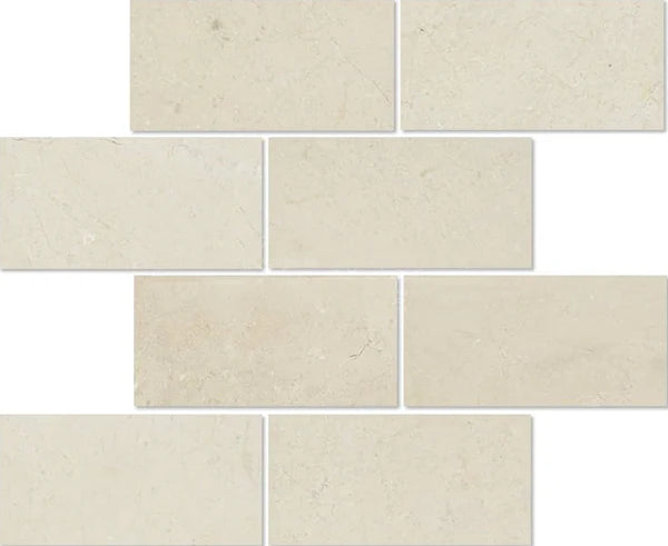 The Crema Marfil Marble 3X6 Polished-Honed tiles from SurfacesGalore are arranged in an offset pattern, creating a brick-like layout. Their smooth surface makes them perfect for a sophisticated kitchen backsplash.