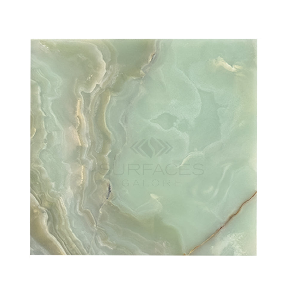 A Green Onyx Premium Marble 12X12 Polished slab with natural wavy patterns and subtle color variations. Text overlay reads "SurfacesGalore." Ideal as a luxury tile, this product offers premium tile options for any elegant space.