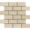 A close-up image of beige brick-patterned Ivory Travertine tiles from SurfacesGalore, specifically the Ivory (Light) Travertine 2X4 Brick Mosaic Filled and Honed. The tiles feature slightly varied shades and natural textures, arranged in a staggered, horizontal layout with thin dark grout lines separating each tile.