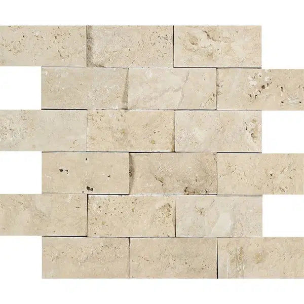 The image shows a wall made of SurfacesGalore's Ivory (Light) Travertine 2X4 Brick Mosaic Split-Faced tiles, arranged in a brick pattern. The tiles have subtle variations in color and texture, with natural imperfections such as small holes and irregularities, creating an organic and rustic look for the surface.