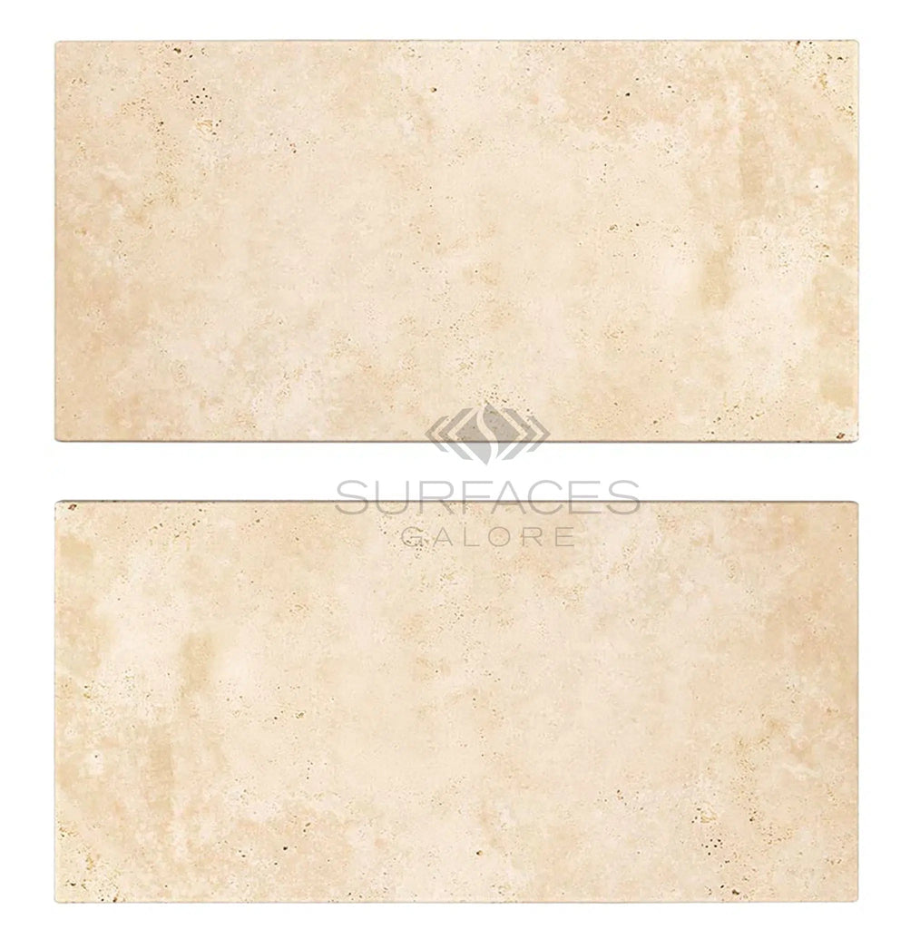 Two beige tiles with a subtle textured surface, branded "SurfacesGalore" in the center, reminiscent of Ivory (Light) Travertine 3X6 (Cross-Cut) Tumbled elegance.