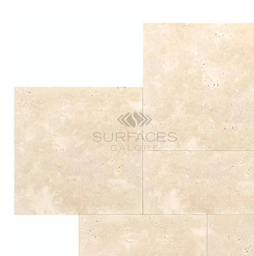 Ivory travertine tiles with a honed finish, arranged neatly in a Versailles pattern. Visible text: "SurfacesGalore" in the center, echoing the elegance of premium marble.