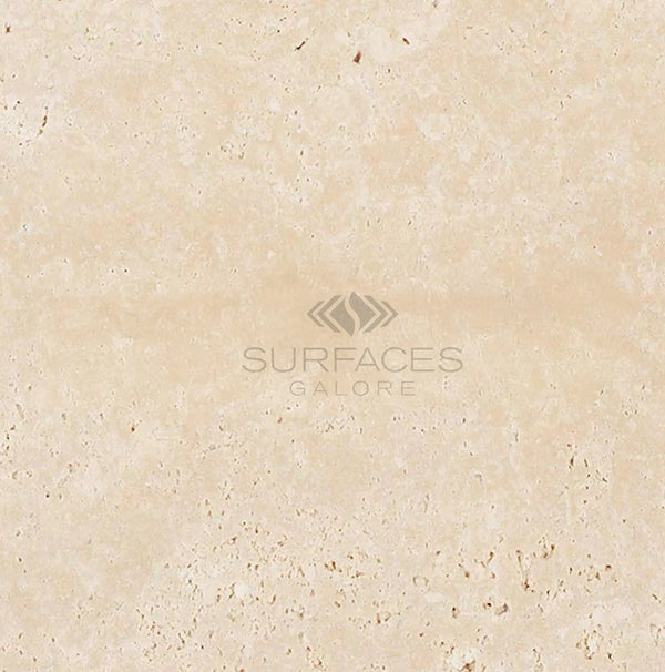 Ivory (Light) Travertine 4X4 (Cross-Cut) Tumbled marble texture with subtle patterns, featuring the "SurfacesGalore" logo with an abstract design in the center.