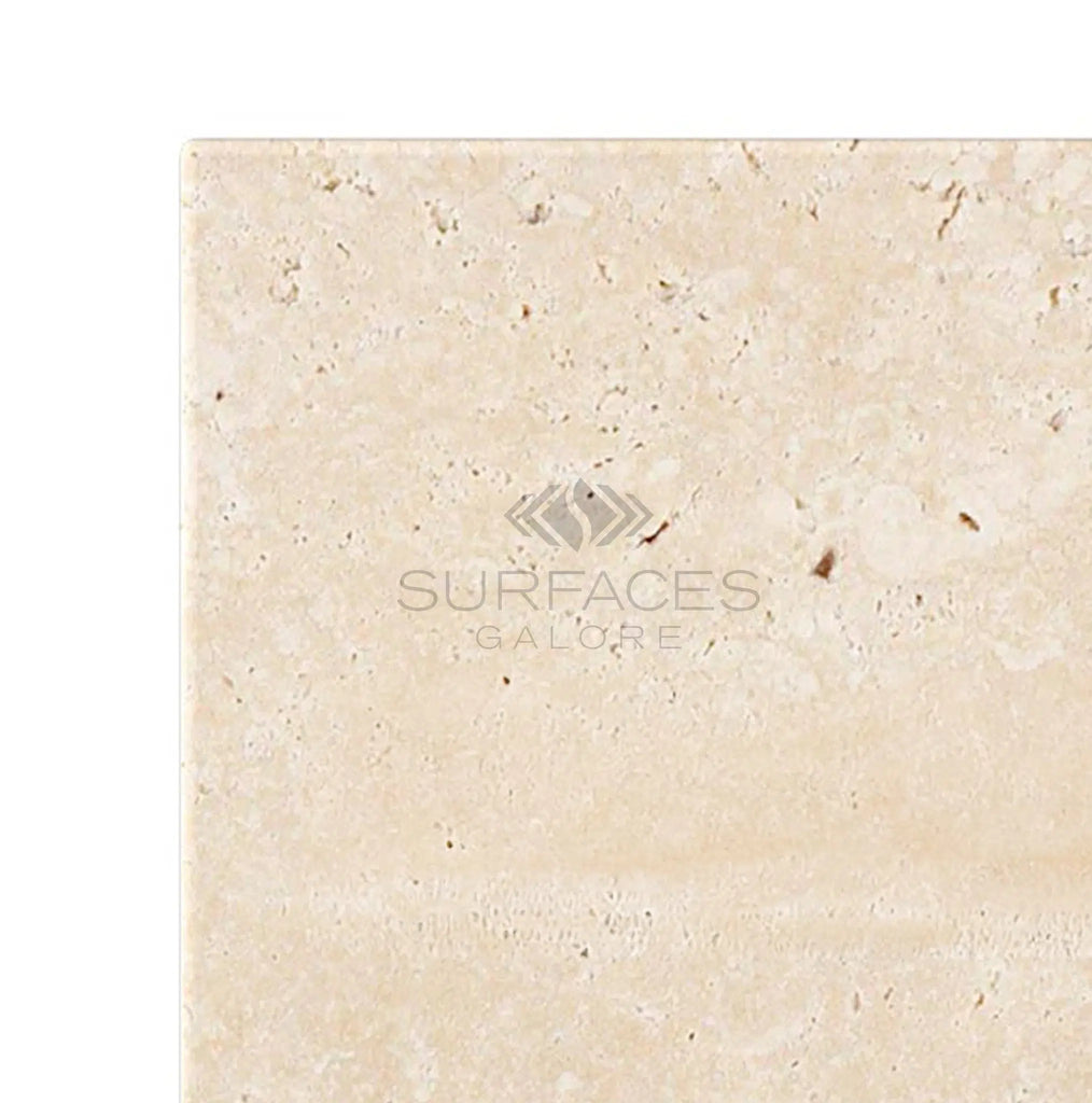 Close-up of a beige marble tile with subtle natural veining and the text "SurfacesGalore" faintly visible, showcasing the elegance of Ivory (Light) Travertine 4X4 (Cross-Cut) Tumbled.