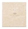 A square beige tile with a speckled pattern and the text "SurfacesGalore" in the center, reminiscent of Ivory (Light) Travertine 4X4 (Cross-Cut) Tumbled.