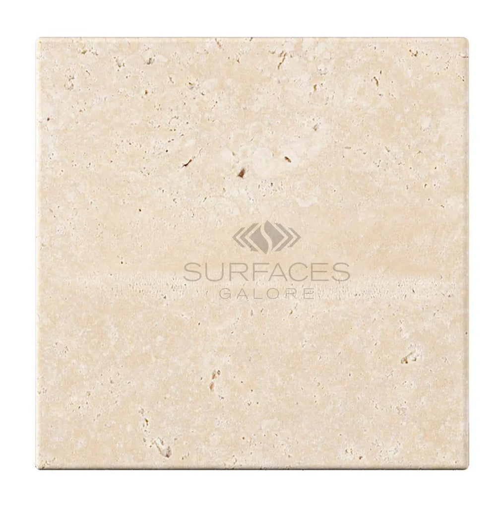 A square beige tile with a speckled pattern and the text "SurfacesGalore" in the center, reminiscent of Ivory (Light) Travertine 4X4 (Cross-Cut) Tumbled.