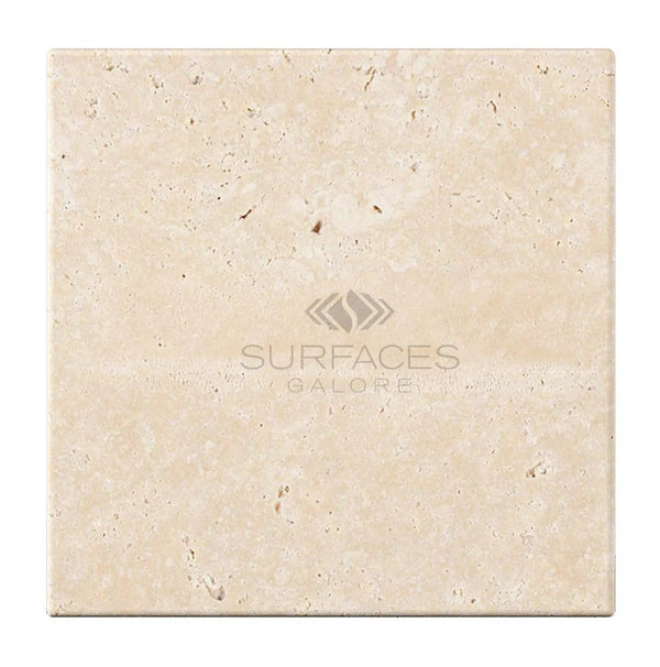 The Ivory (Light) Travertine 6X6 (Cross-Cut) Tumbled tile from SurfacesGalore, a square beige stone tile with subtle natural texture, exudes elegance.