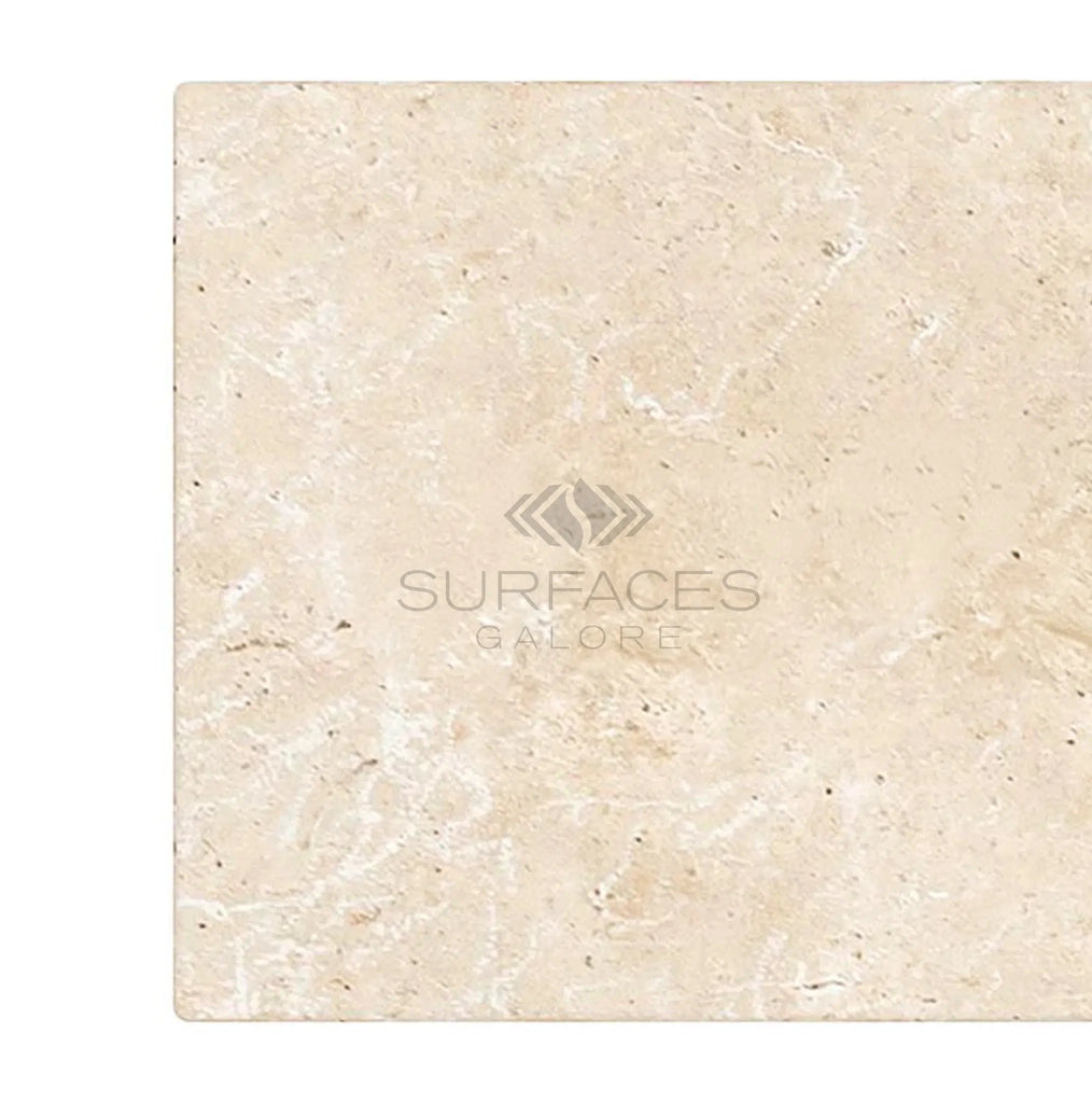 Ivory (Light) Travertine 8X16 (Cross-Cut) Tumbled tile with subtle veins, featuring "SurfacesGalore" elegantly printed in the center, reminiscent of light beige marble.