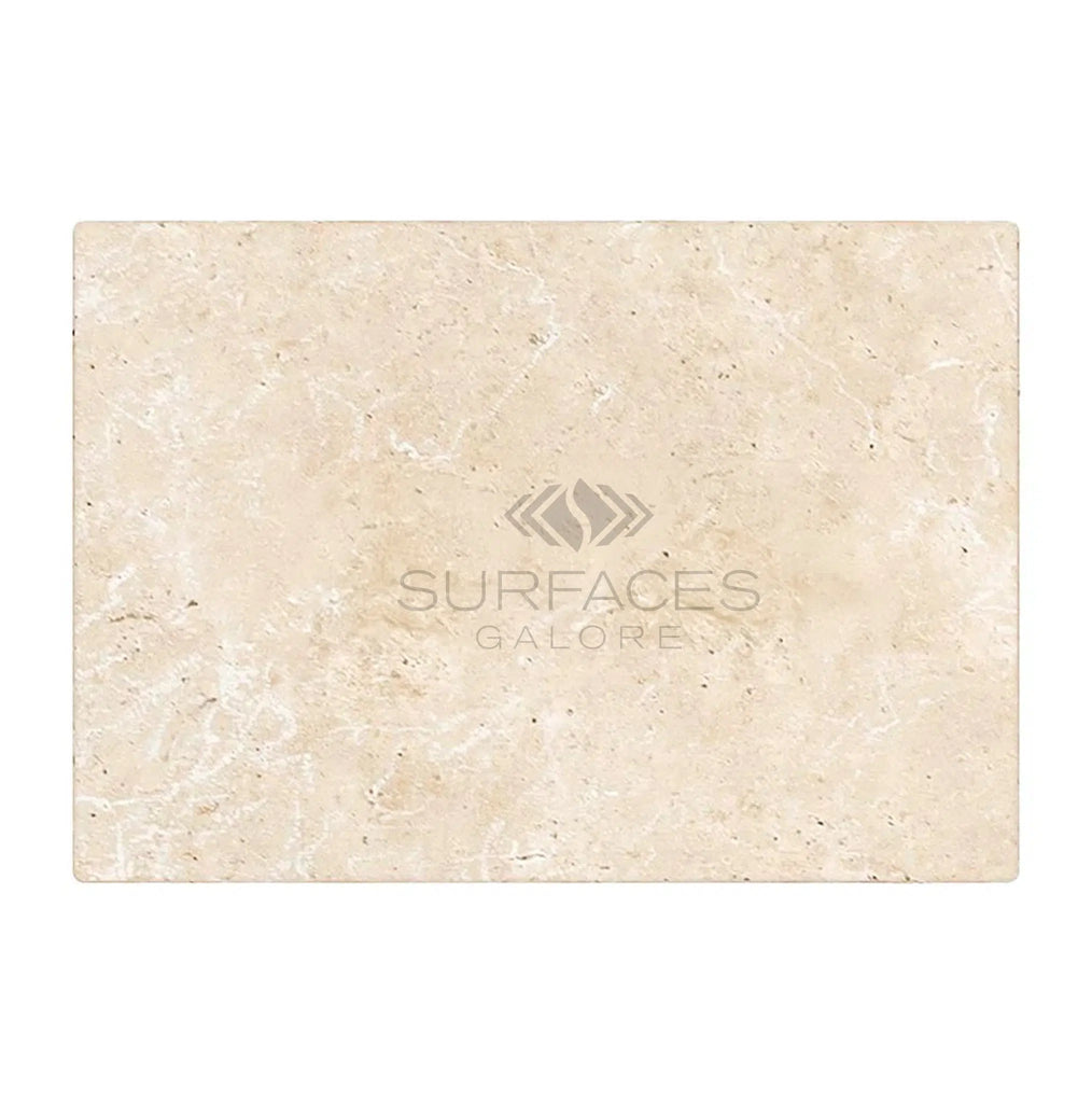 An Ivory (Light) Travertine 8x16 (Cross-Cut) Tumbled tile with a subtle texture, featuring the SurfacesGalore logo in the center, reminiscent of Light Travertine.