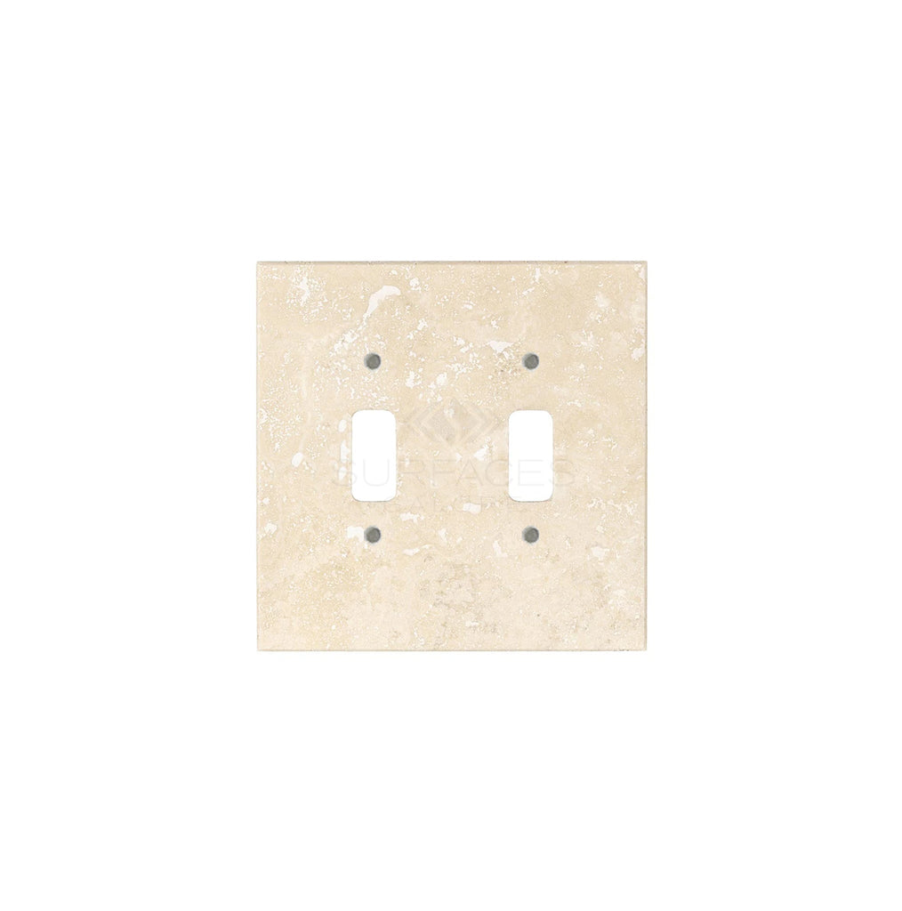 The SurfacesGalore Ivory (Light) Travertine Double TOGGLE Plate Switch Wall Plate boasts a luxurious square design with two vertical switch openings, crafted from authentic travertine stone in a beautiful beige finish—perfect for upscale home decor.