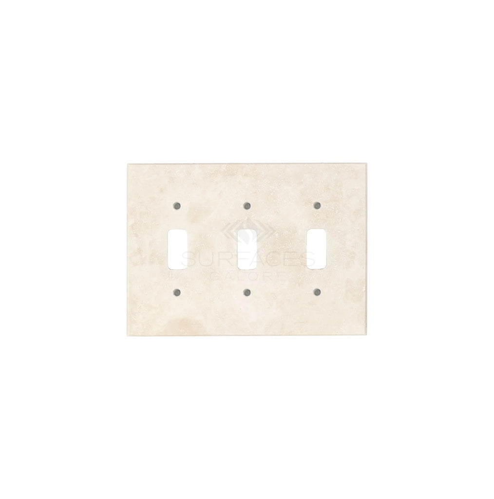 The Ivory (Light) Travertine Triple TOGGLE Switch Wall Plate from SurfacesGalore features three rectangular cutouts for switches and six screw holes, showcasing authentic marble with natural stone variations.