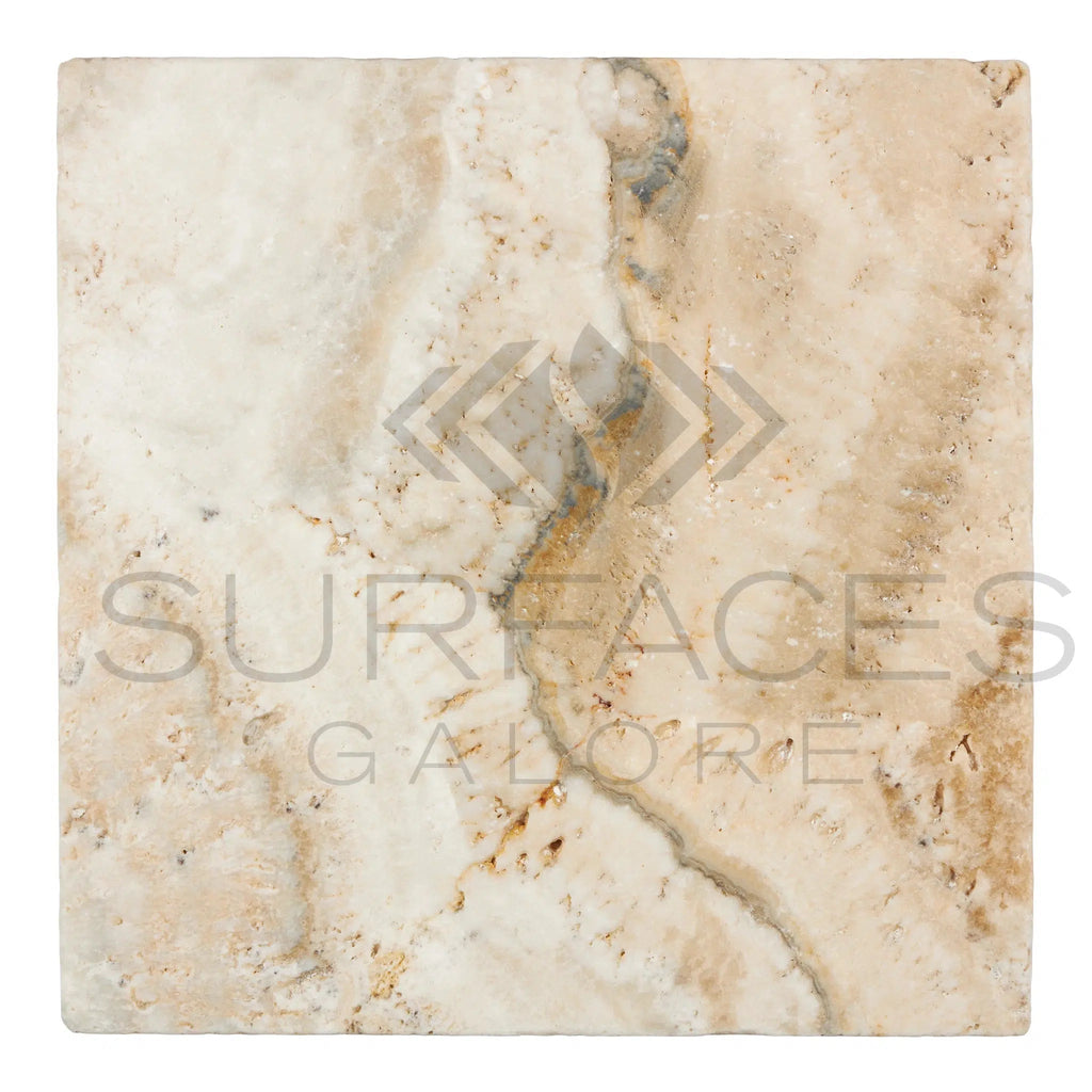 The La Travonya Travertine 12X12 Filled and Honed tile by SurfacesGalore is a square beige tile adorned with natural veining patterns in shades of brown and grey. It boasts a slightly shiny finish with intricate details, radiating natural elegance. The image features the text “SURFACES GALORE” in large, semi-transparent letters.