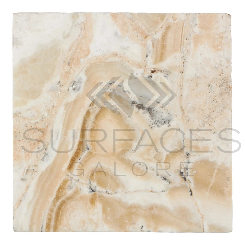 A 12x12 square tile from SurfacesGalore, named La Travonya Travertine Filled and Honed, with a natural marble pattern in beige, white, and light brown tones, featuring wavy and swirled lines. The semi-transparent text "SurfacesGalore" is overlaid across the tile, highlighting its durability and natural elegance.