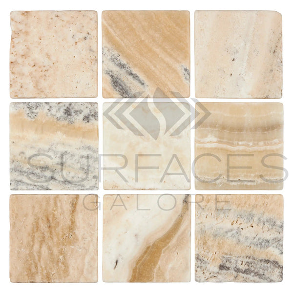 Nine La Travonya Travertine 12X12 Filled and Honed tiles from SurfacesGalore, displaying various shades and patterns of beige, white, and gray marble, are arranged in a 3x3 grid, showcasing natural elegance. Each tile features unique swirls and veining. The "SurfacesGalore" logo is overlaid at the center, featuring two stylized arrows and a flame icon.