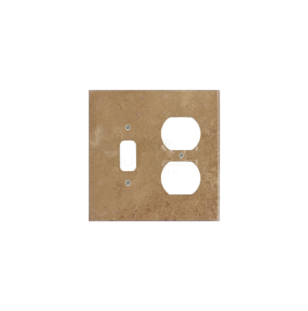 A Noce Travertine switch plate cover from SurfacesGalore, rectangular in shape and tan in color, made from authentic marble, featuring a slot for a toggle switch and one for a double outlet.