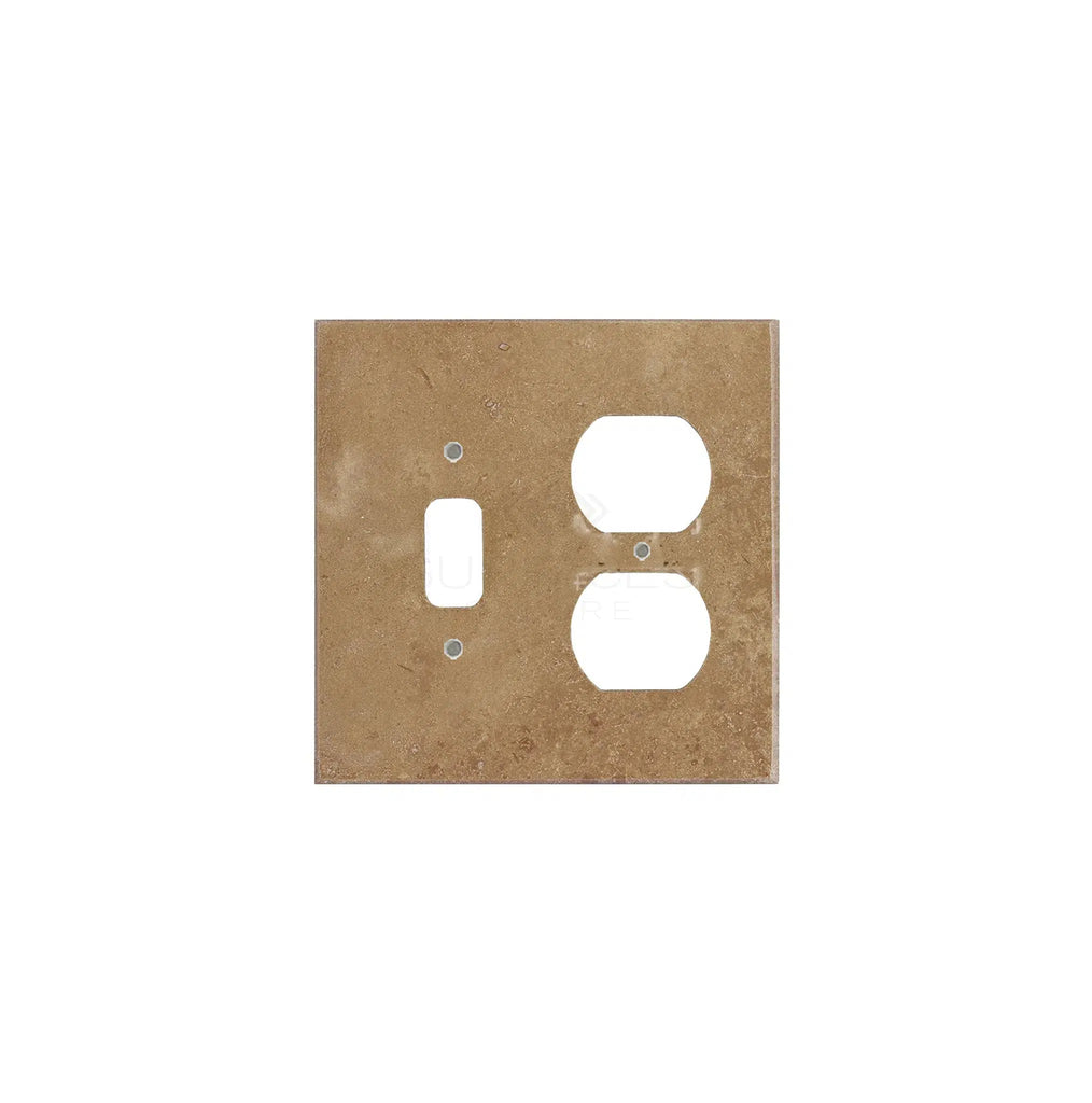 A Noce Travertine switch plate cover from SurfacesGalore, rectangular in shape and tan in color, made from authentic marble, featuring a slot for a toggle switch and one for a double outlet.