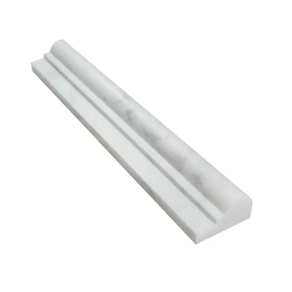 The Oriental White / Asian Statuary 2X12 OG-1 (Single-Step Chair Rail Trim) Liner Polished-Honed by SurfacesGalore features a beveled edge and a subtle gray veining pattern, perfect for doorways and transitions.