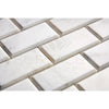 White rectangular marble tiles arranged in an offset pattern with subtle grey veining, showcasing the classic aesthetic of SurfacesGalore's Oriental White / Asian Statuary 2X4 Brick Deep-Beveled Marble Mosaic Polished-Honed.