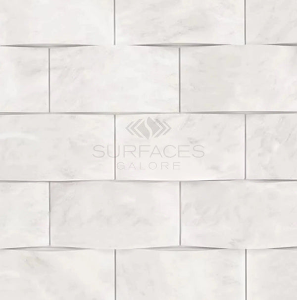 The Oriental White / Asian Statuary 2X4 Round-Faced (CNC-Arched/Wavy) Marble Mosaic Polished-Honed tiles from SurfacesGalore are arranged in a staggered pattern, with the text "SurfacesGalore" faintly visible, exuding an air of luxury and timeless elegance.