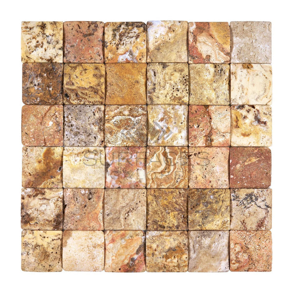 A grid of 6x6 small square stone tiles with various earthy tones and natural textures, perfect for versatile applications. The Scabos Travertine 2X2 CNC-Arched & Tumbled (Round-Face / Wavy) Mosaic by SurfacesGalore adds a touch of vibrant colors, arranged neatly to enhance any space.