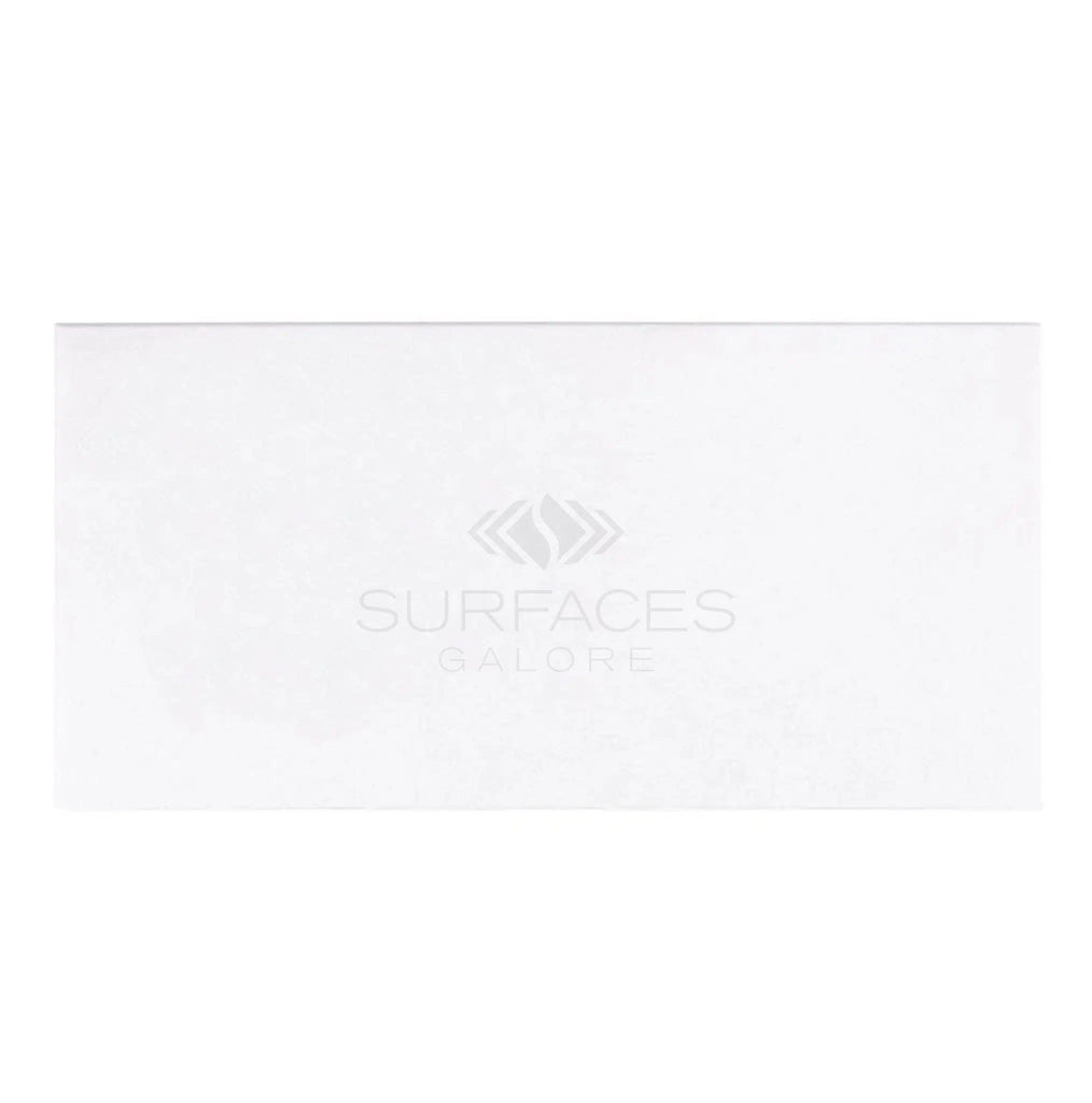 This polished-honed Thassos White (Greek) 12X24 marble tile from SurfacesGalore features a subtle embossed logo in the center, reminiscent of elegant Greek marble.