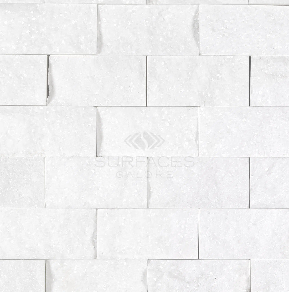 Close-up of a crystalline textured brick wall with the text "SurfacesGalore" in the center, reminiscent of Thassos White (Greek) 1X2 Brick Mosaic Marble Split-Faced.