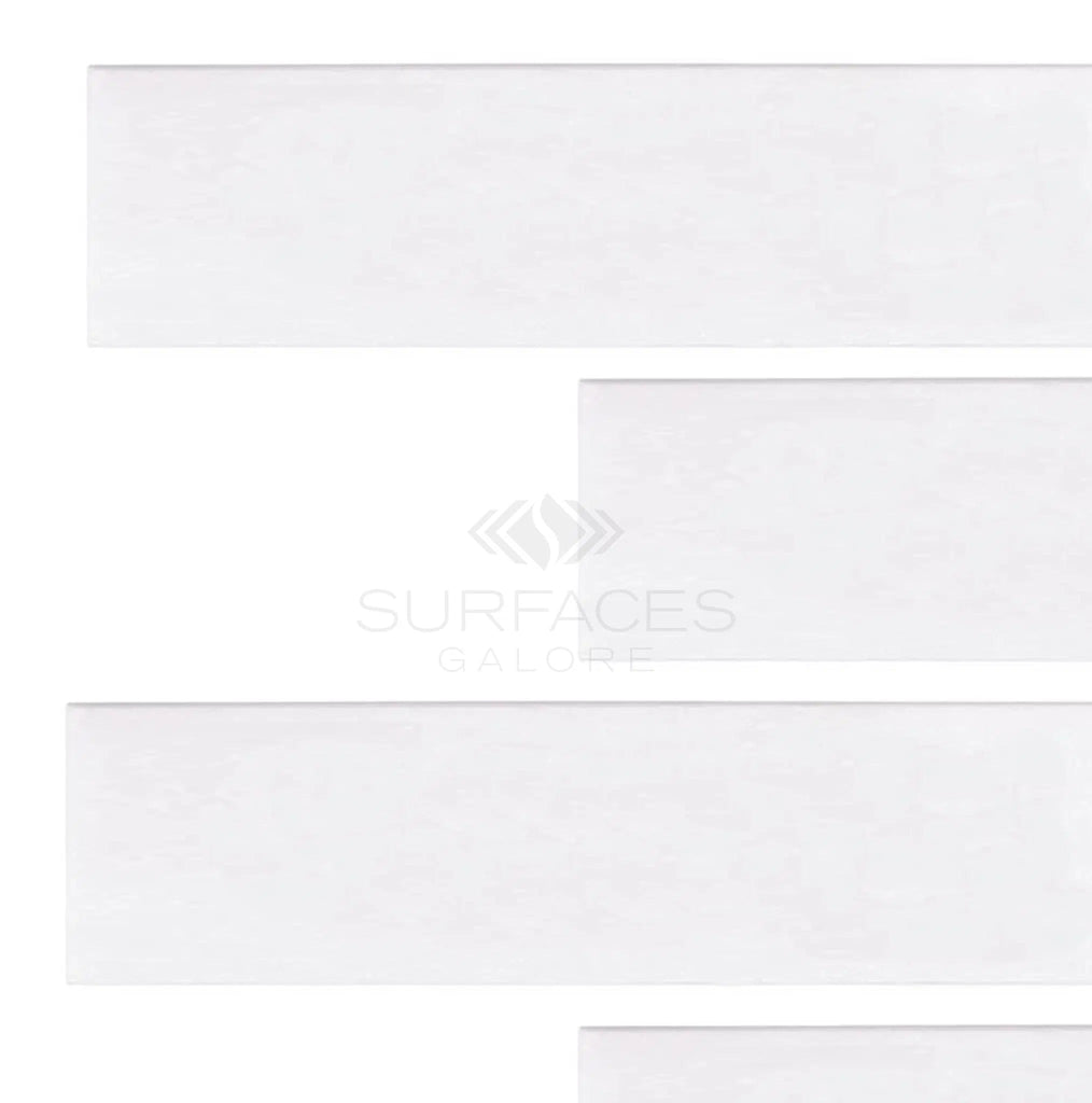 White rectangular tiles placed horizontally on a pure white background, with the text "SurfacesGalore" faintly visible, echoing the elegance of Thassos White (Greek) 2x8 Marble Polished-Honed.