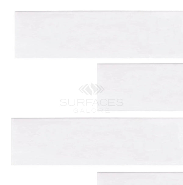 White rectangular tiles placed horizontally on a pure white background, with the text "SurfacesGalore" faintly visible, echoing the elegance of Thassos White (Greek) 2x8 Marble Polished-Honed.