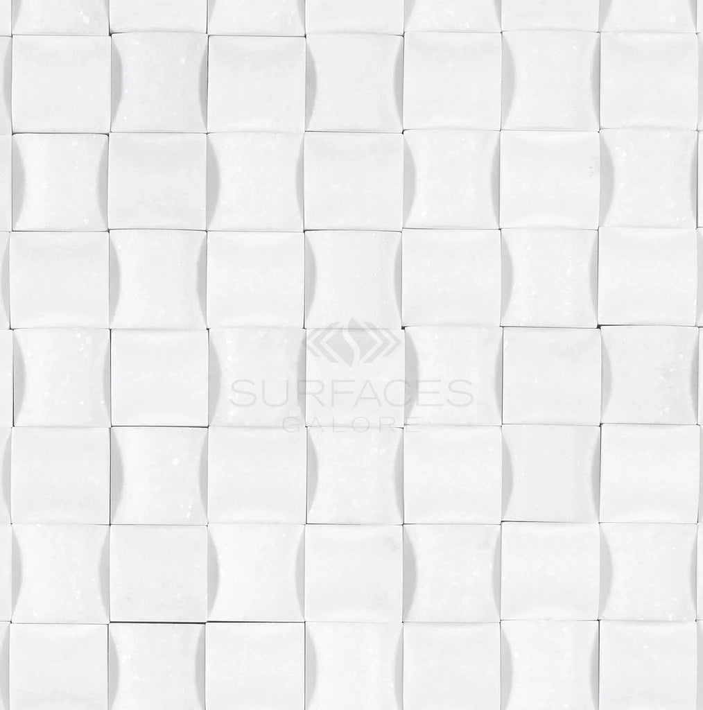 Thassos White (Greek) 3-D Small-Bread Mosaic Marble Polished-Honed, featuring a white textured tile pattern with a wavy 3D design reminiscent of pure white marble, and the SurfacesGalore logo in the center.