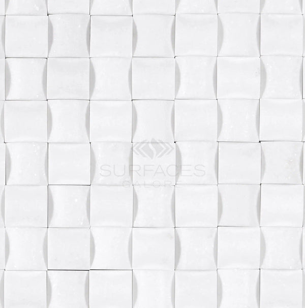 Thassos White (Greek) 3-D Small-Bread Mosaic Marble Polished-Honed, featuring a white textured tile pattern with a wavy 3D design reminiscent of pure white marble, and the SurfacesGalore logo in the center.