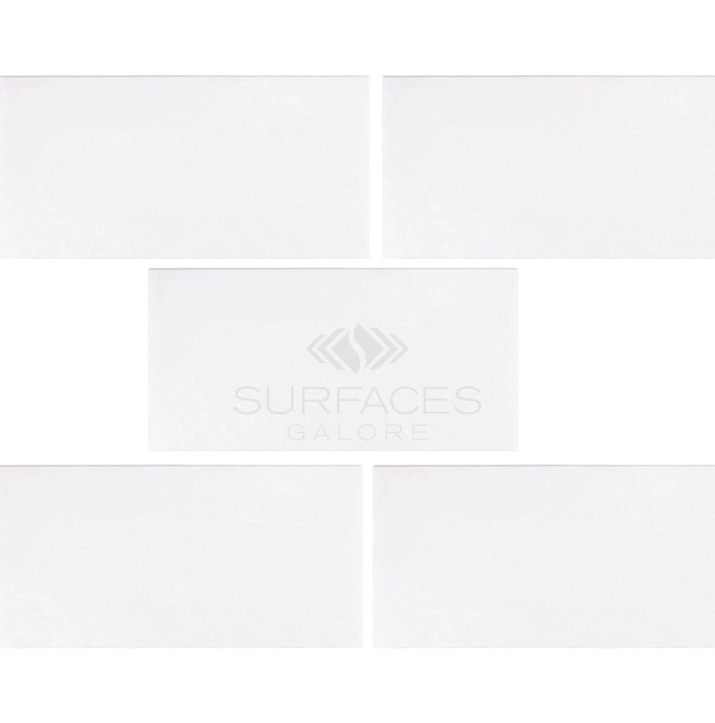 Five Thassos White (Greek) 3X6 Marble Polished-Honed tiles, showcasing a crystalline texture, are arranged with the SurfacesGalore logo in the center.