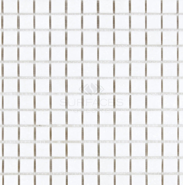 A grid of small Thassos White (Greek) 5/8X5/8 Mosaic Marble tiles from SurfacesGalore, polished and honed, with thin grout lines forming a uniform pattern.