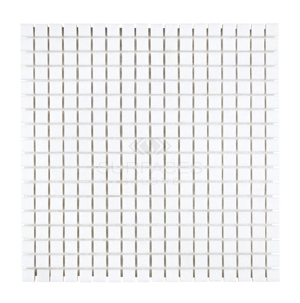 A grid of small, white square tiles from SurfacesGalore, specifically the Thassos White (Greek) 5/8X5/8 Mosaic Marble Polished-Honed, arranged in rows and columns on a flat surface.