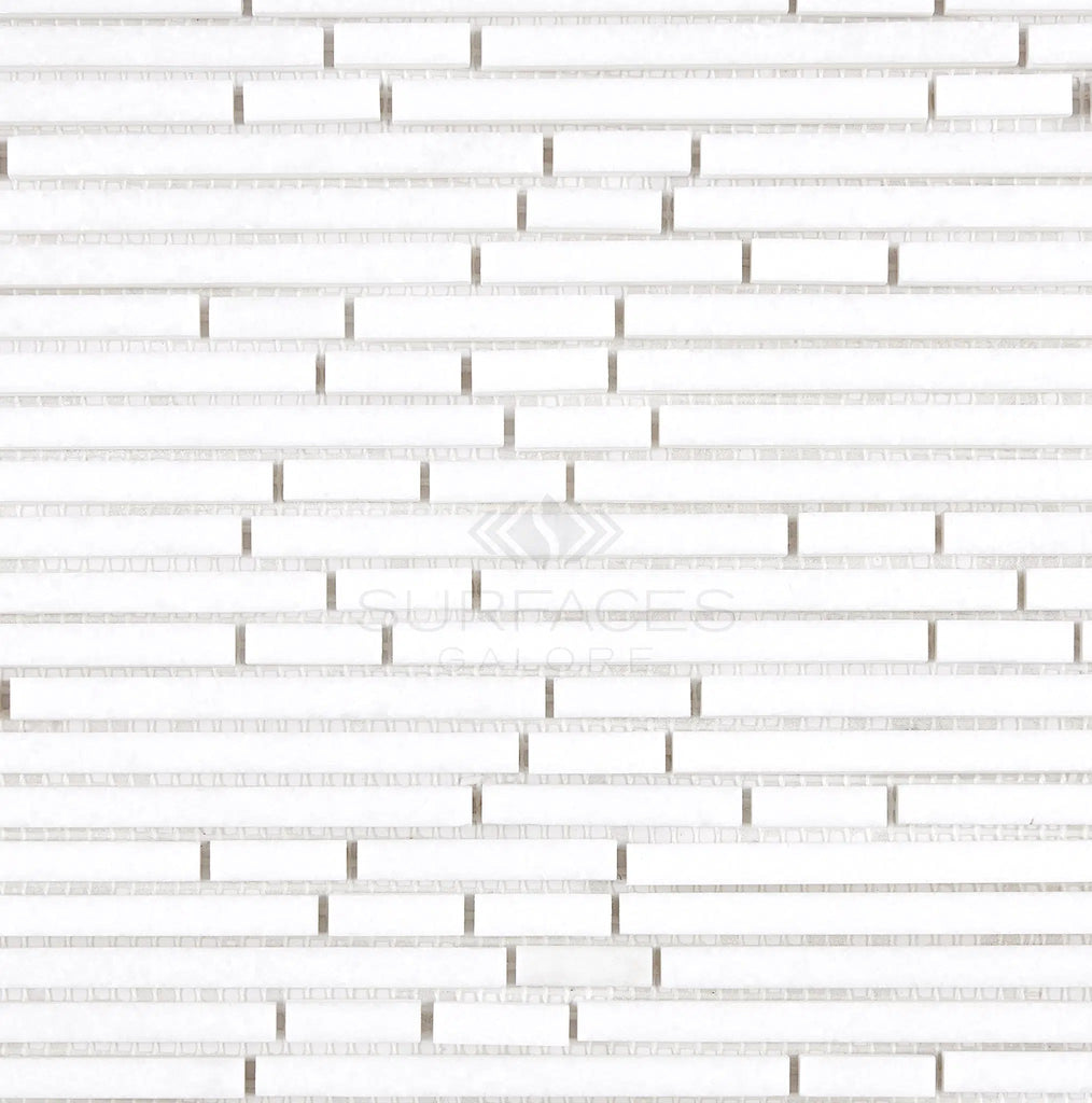 A close-up of the Thassos White (Greek) Bamboo Sticks Mosaic Marble Polished-Honed tile pattern with staggered rectangular tiles and subtle texture, showcasing the elegance of pure white marble from SurfacesGalore.