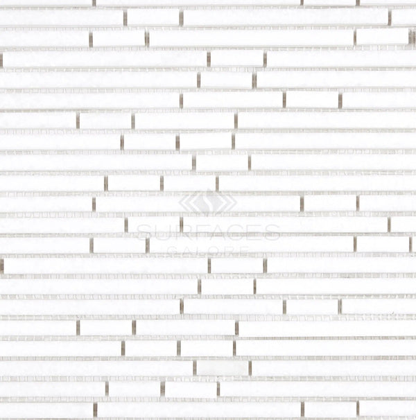 A close-up of the Thassos White (Greek) Bamboo Sticks Mosaic Marble Polished-Honed tile pattern with staggered rectangular tiles and subtle texture, showcasing the elegance of pure white marble from SurfacesGalore.