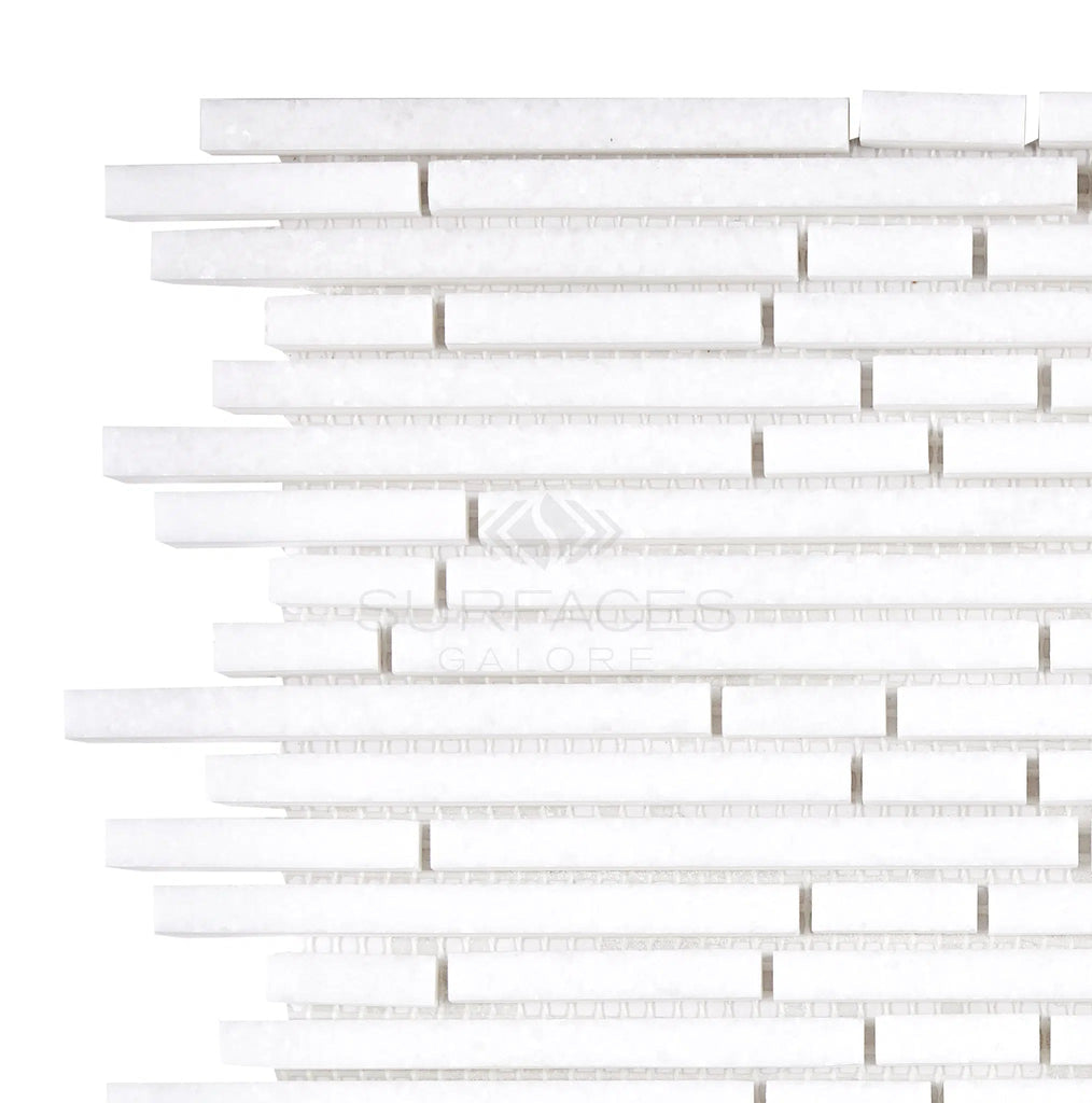 The SurfacesGalore Thassos White (Greek) Bamboo Sticks Mosaic Marble Polished-Honed features a white stacked stone tile pattern with varying thicknesses, creating a modern and textured design using Thassos White Marble.