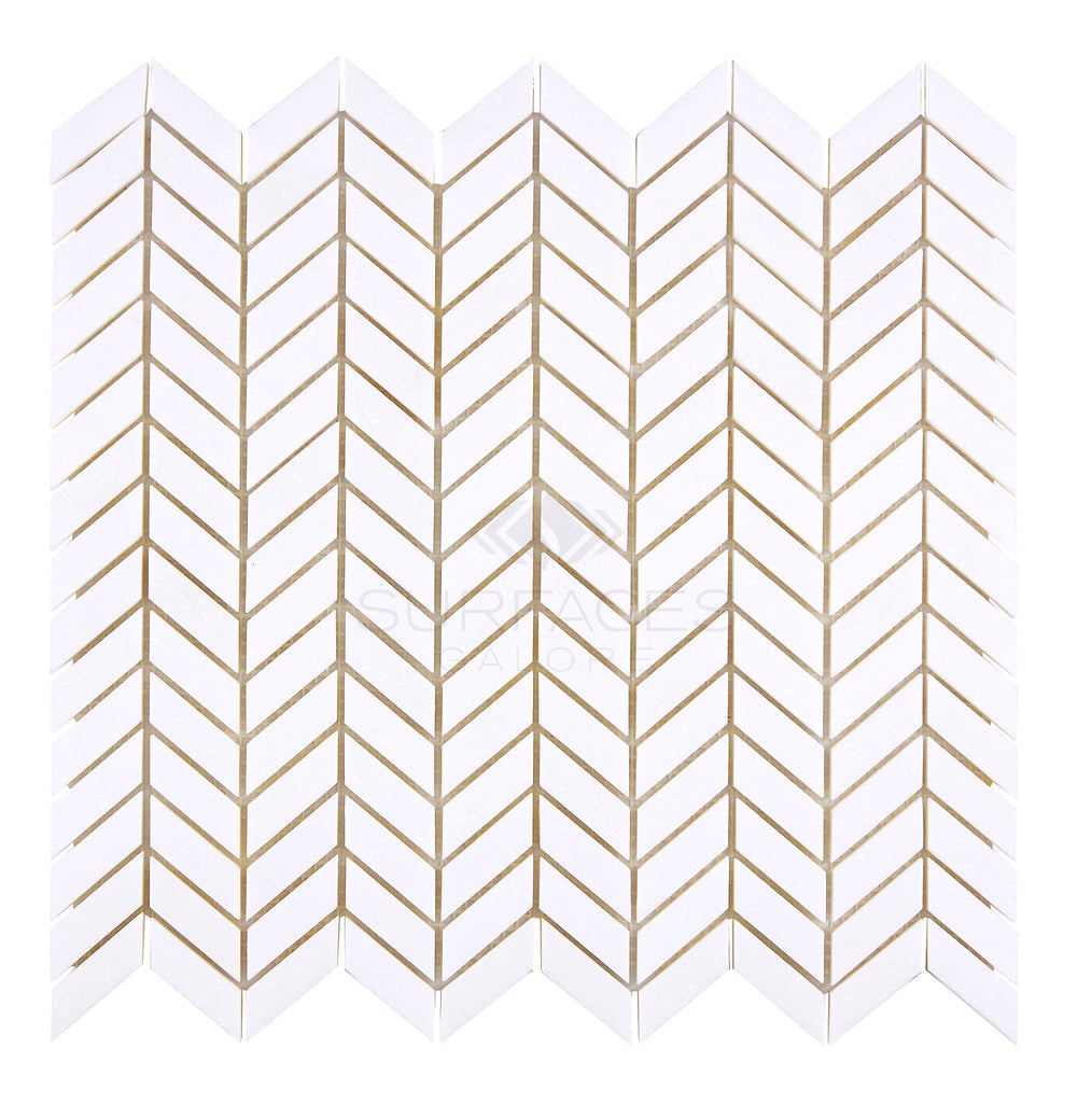 Transform your space with the stunning Thassos White (Greek) Chevron (Mini) Mosaic Marble Polished-Honed tiles from SurfacesGalore. When paired with beige grout, these elegant tiles create a striking zigzag pattern that offers both luxury and timeless aesthetic to any room.