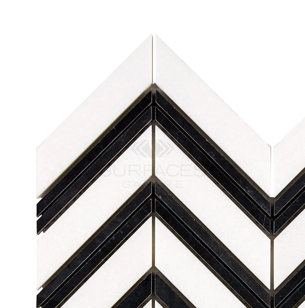 The Thassos White (Greek) Large Chevron (w/ Black) Mosaic Marble Polished-Honed from SurfacesGalore features a black and white chevron-patterned tile design with alternating stripes against a pure white marble background.