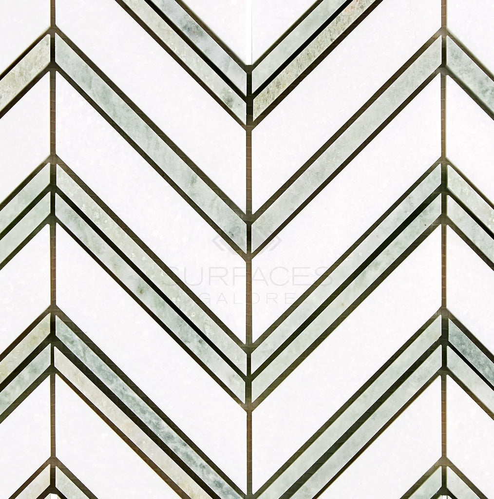 Green tile design with a chevron pattern and metallic accents, featuring the polished-honed Thassos White (Greek) Large Chevron Mosaic Marble from SurfacesGalore.