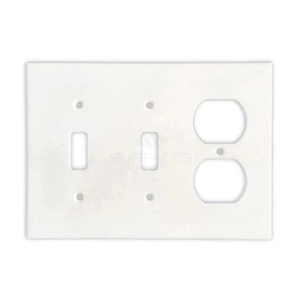 The SurfacesGalore Thassos White Marble Double TOGGLE - DUPLEX Switch Wall Plate offers a stylish and functional addition to your natural stone décor, featuring one switch slot on the left and one duplex outlet slot on the right. Note that hardware is not included.