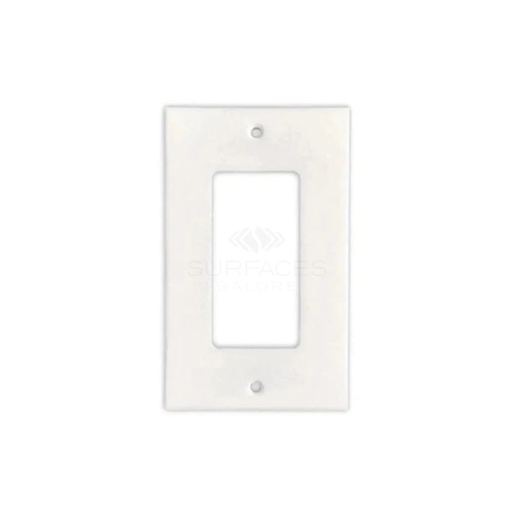 The Thassos White Marble Single ROCKER Plate Switch Wall Plate from SurfacesGalore features an elegant design that mimics the look of authentic marble, adding a subtle yet sophisticated touch to your décor. It has two screw holes and is displayed on a plain white background.