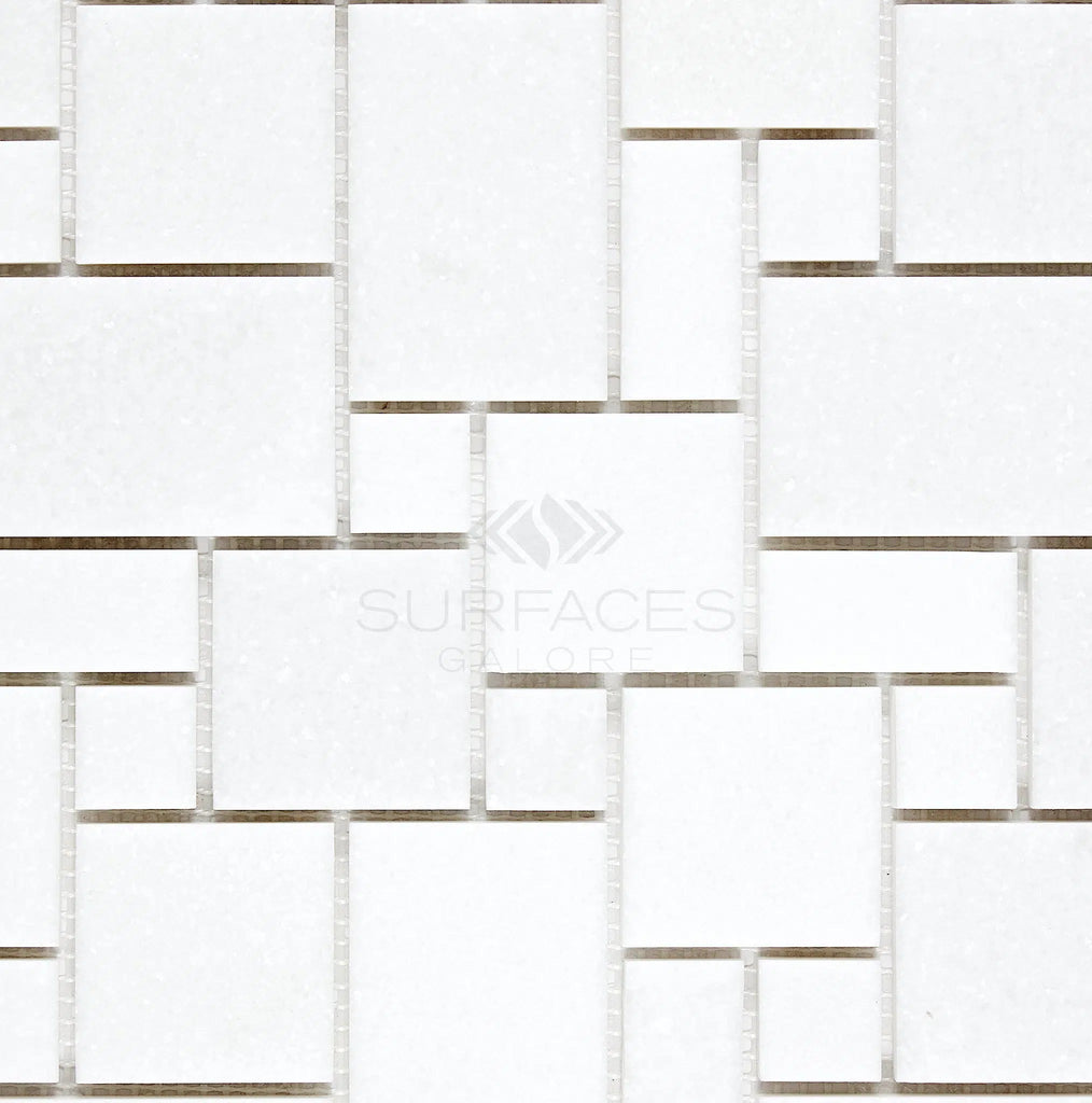 The Thassos White (Greek) Mini-Versailles Pattern Mosaic Marble Polished-Honed tiles from SurfacesGalore feature a polished, honed finish and white rectangular tiles arranged in a geometric pattern with varying sizes and gaps, perfect for achieving an elegant look.