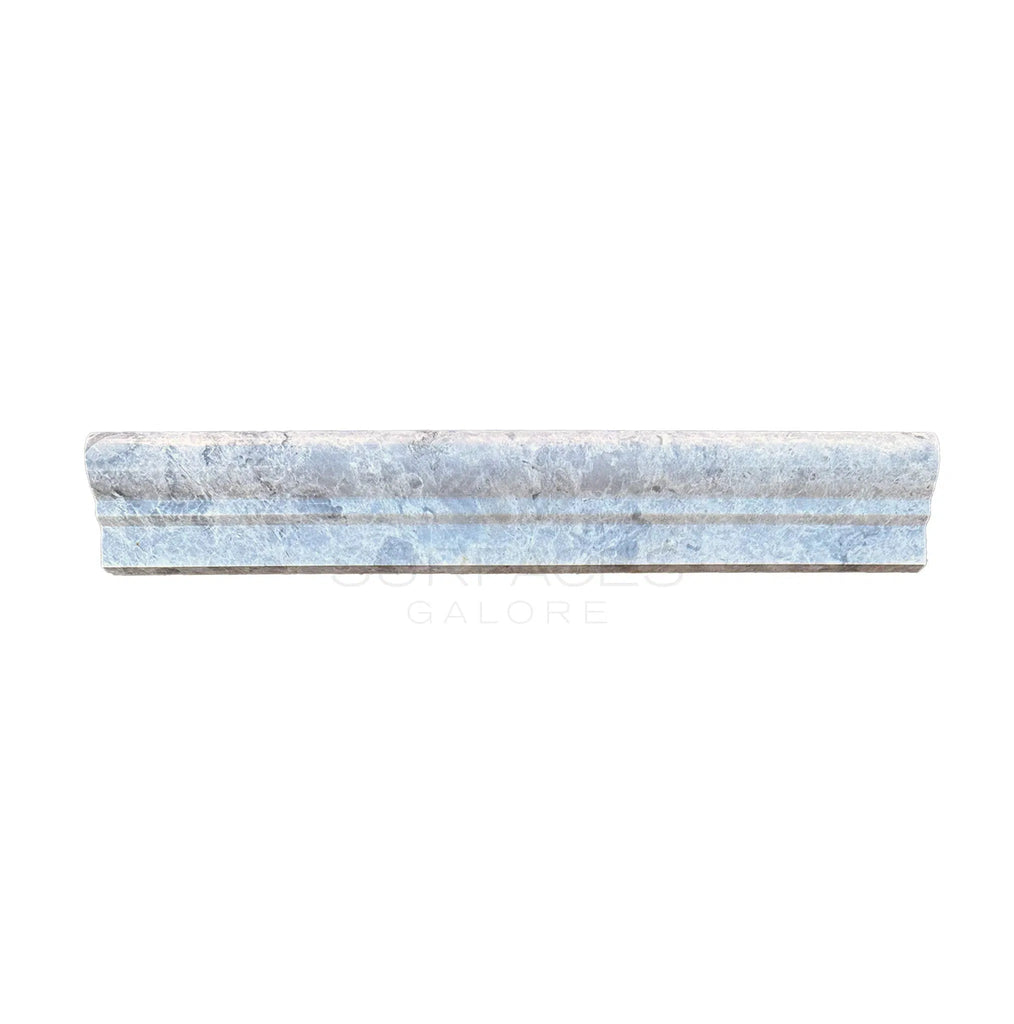 A versatile Tundra Gray 2X12 OG-1 (Single-Step Chair Rail Trim) Liner Marble Polished-Honed tile from SurfacesGalore with a textured surface, isolated on a white background.