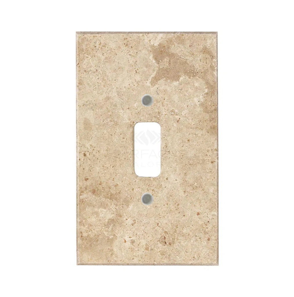 A walnut travertine single toggle plate switch cover from SurfacesGalore, featuring a rectangular opening and showcasing natural stone variations. This authentic marble wall plate adds an elegant touch to any room.